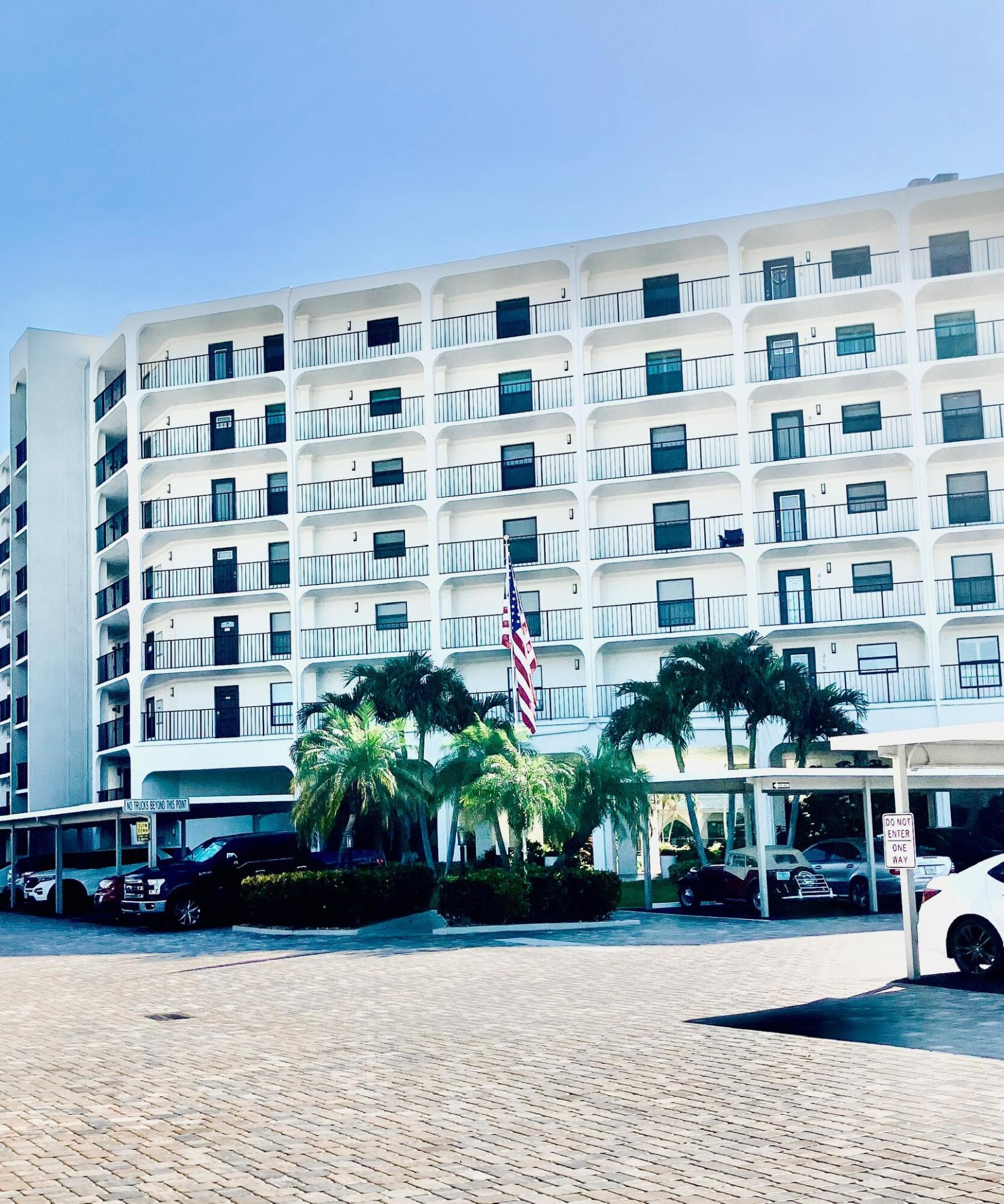 1629 Riverview Road, Unit 716 Deerfield Beach, FL 33441 - Photo 3 of 44 a front view of a building with cars parked