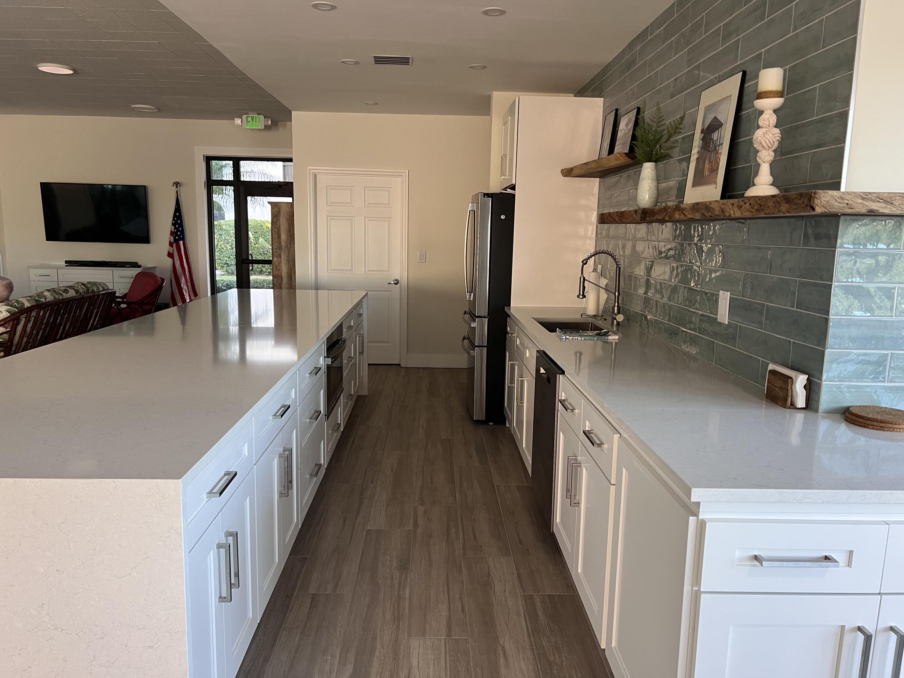 1629 Riverview Road, Unit 716 Deerfield Beach, FL 33441 - Photo 38 of 44 a kitchen with counter top space stainless steel appliances and wooden floor