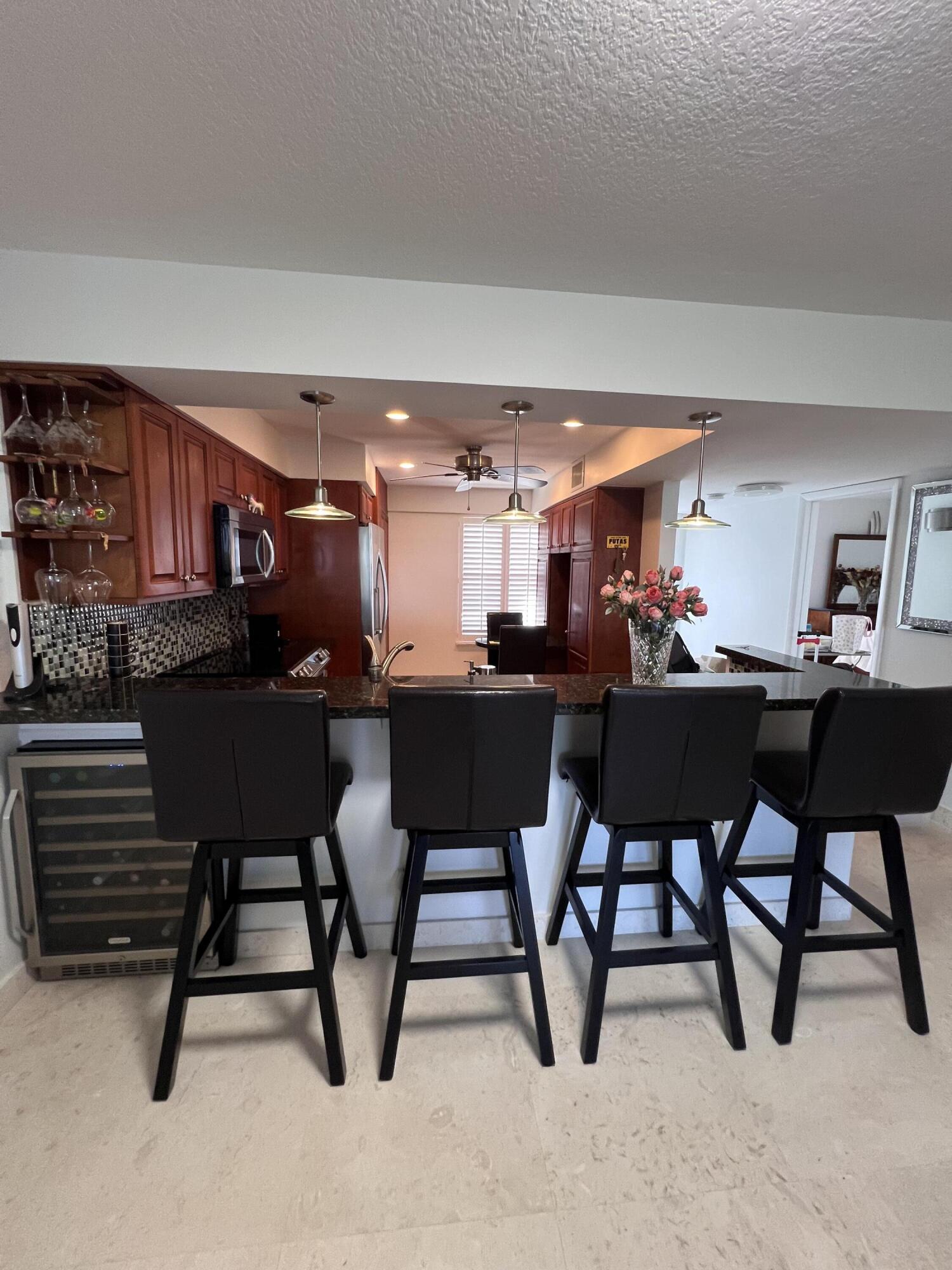 1629 Riverview Road, Unit 716 Deerfield Beach, FL 33441 - Photo 8 of 44 a view of a dining room with furniture