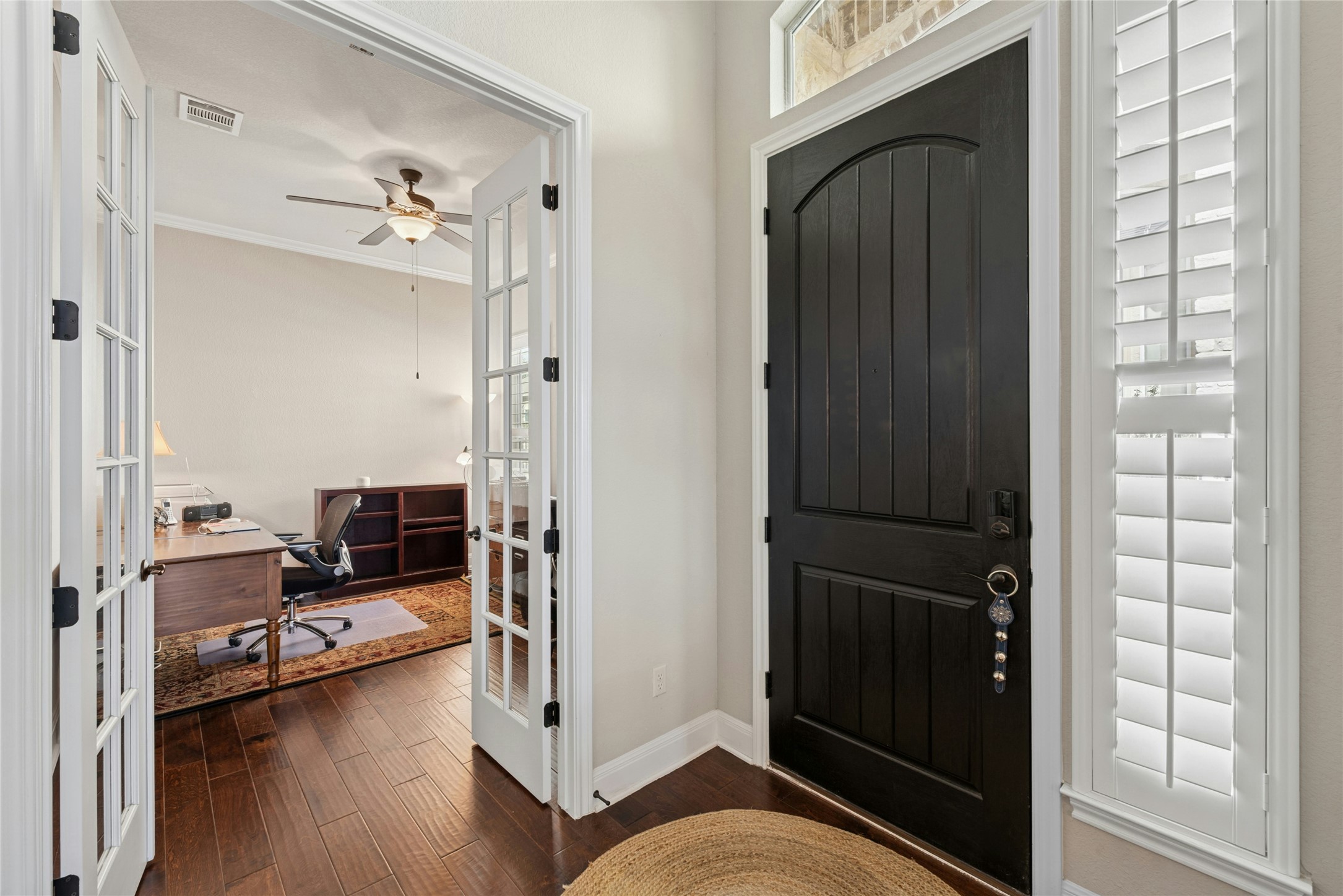 116 Evolutions Path Lakeway, TX 78738 - Photo 6 of 34 Entrance foyer featuring french doors, dark wood-type flooring, ceiling fan, and ornamental molding
