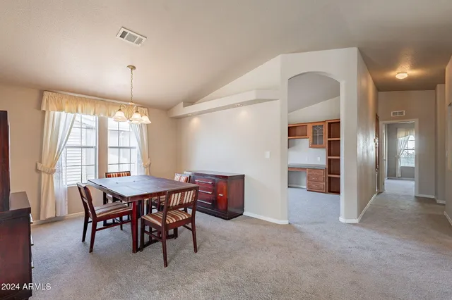a dining room with furniture and window