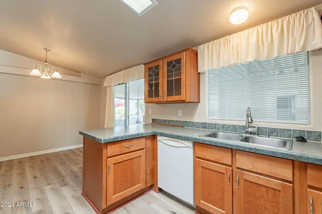 a kitchen with granite countertop cabinets sink and stainless steel appliances