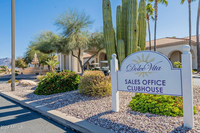 a front view of a house with garden and sitting area