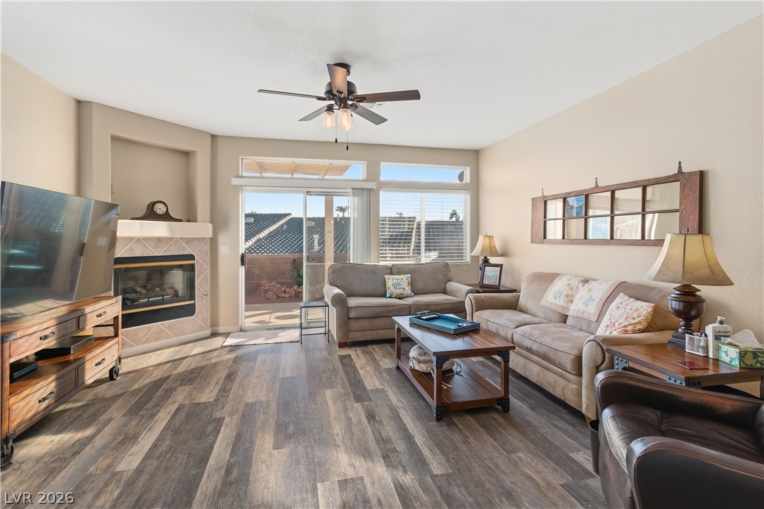 3350 Pheasant Canyon Way, Unit 1008 Laughlin, NV 89029 - Photo 11 of 80 Living area with a tiled fireplace, dark wood finished floors, and ceiling fan