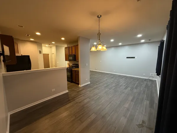 a view of a kitchen with a sink and refrigerator
