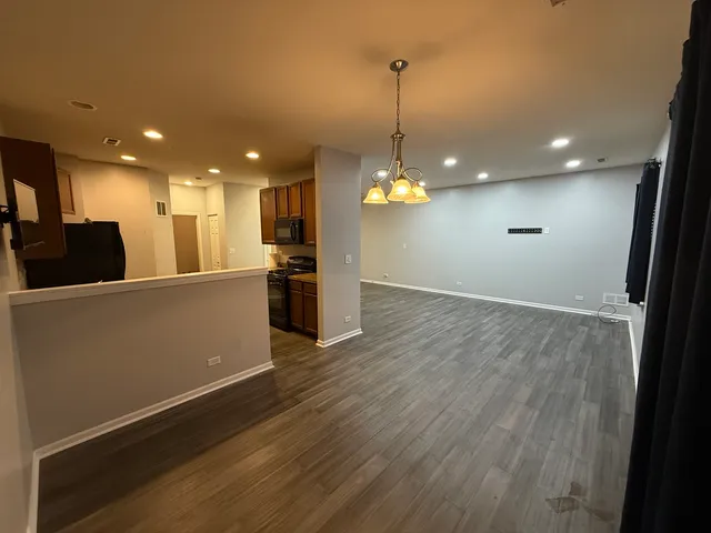 a view of a kitchen with a sink and refrigerator