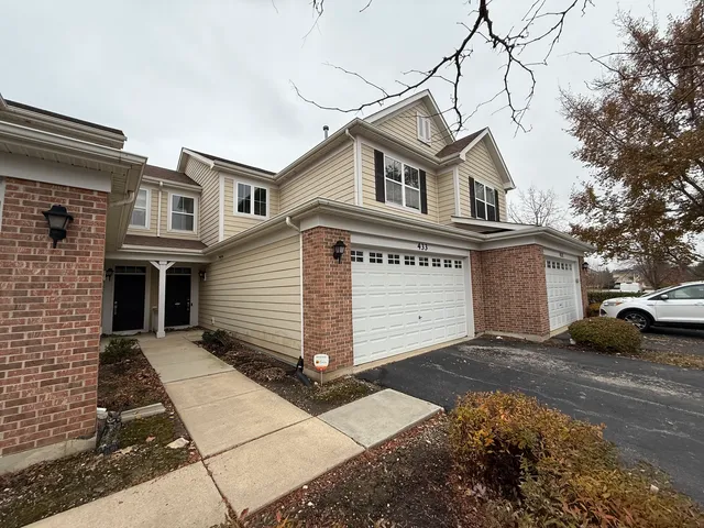 a view of a white house with a street