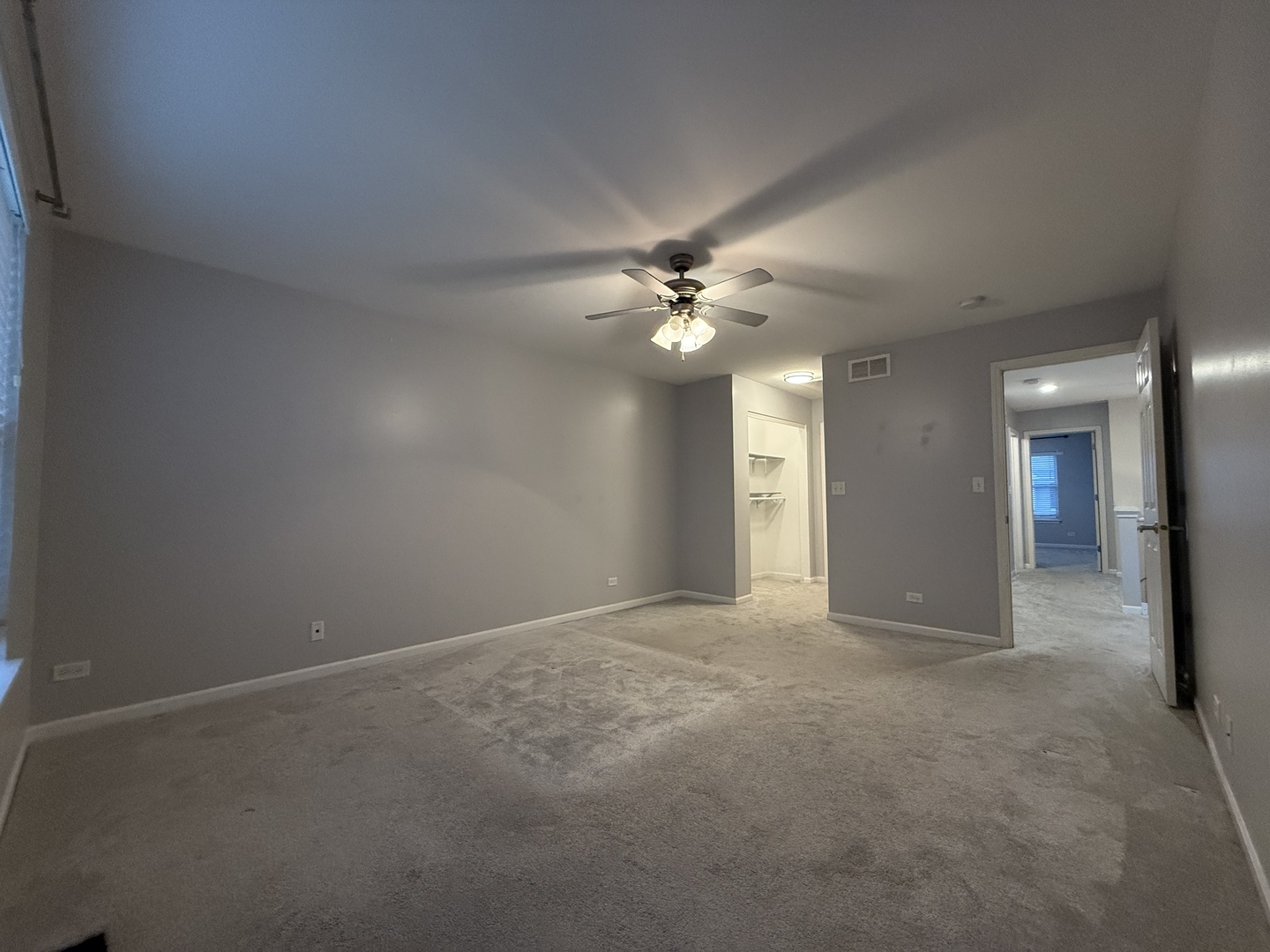 433 Acushnet Street, Unit 433 Elgin, IL 60124 - Photo 22 of 37 a view of an empty room with a chandelier fan