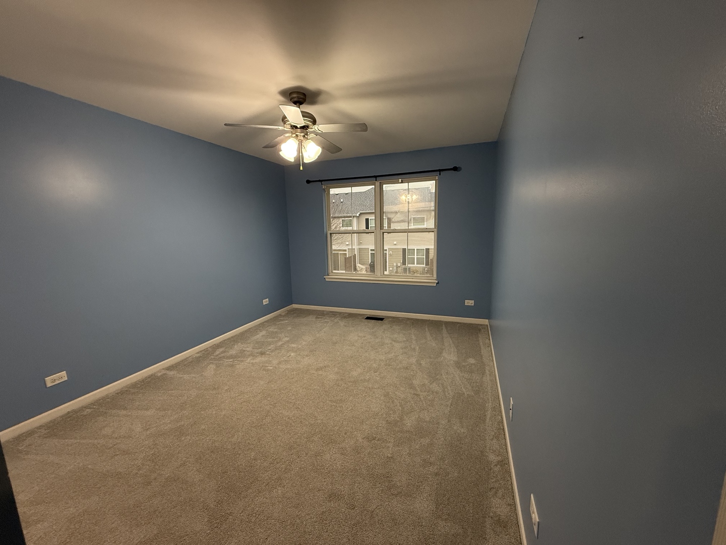 433 Acushnet Street, Unit 433 Elgin, IL 60124 - Photo 27 of 37 an empty room with a chandelier fan and windows