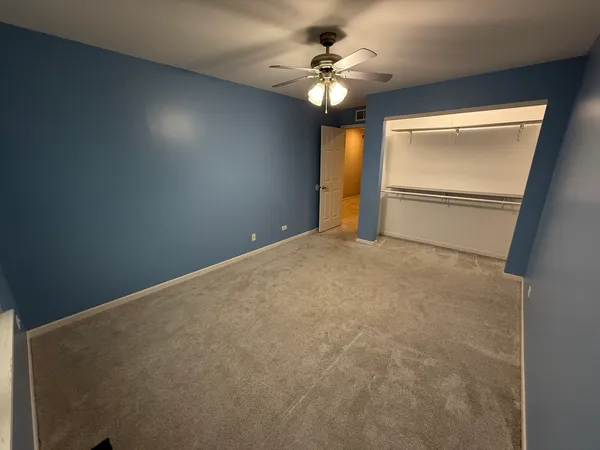 a view of a livingroom with a ceiling fan and window