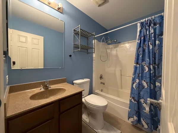 an empty room with closet and windows