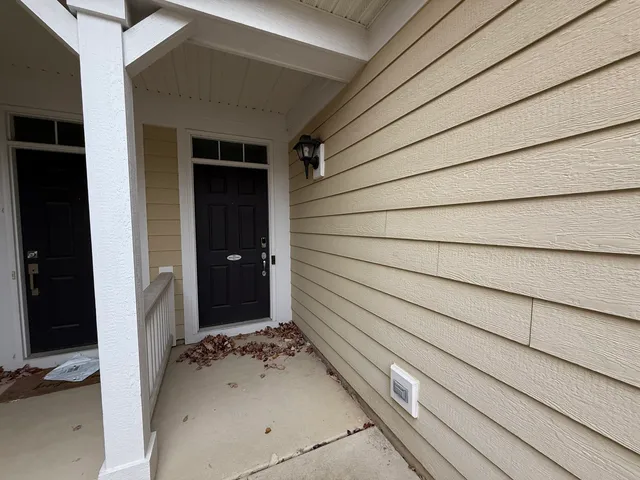 a view of a front door and wooden door