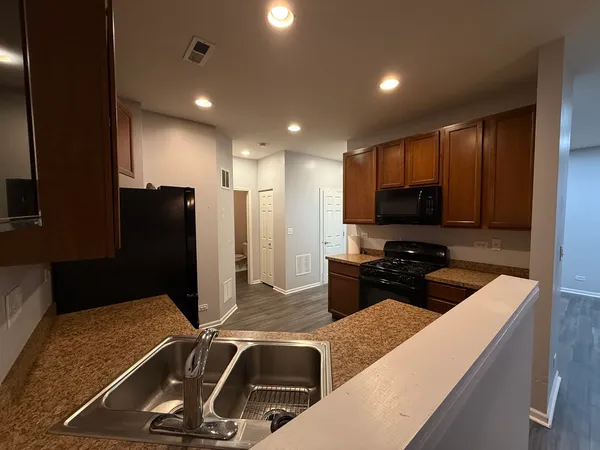 a kitchen with a sink and refrigerator