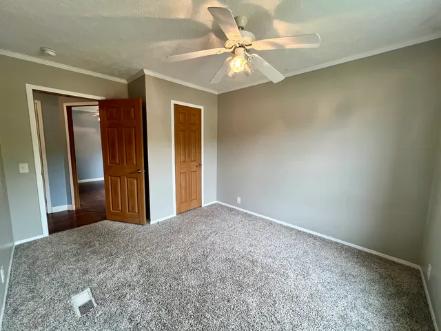 a view of a livingroom with a chandelier fan