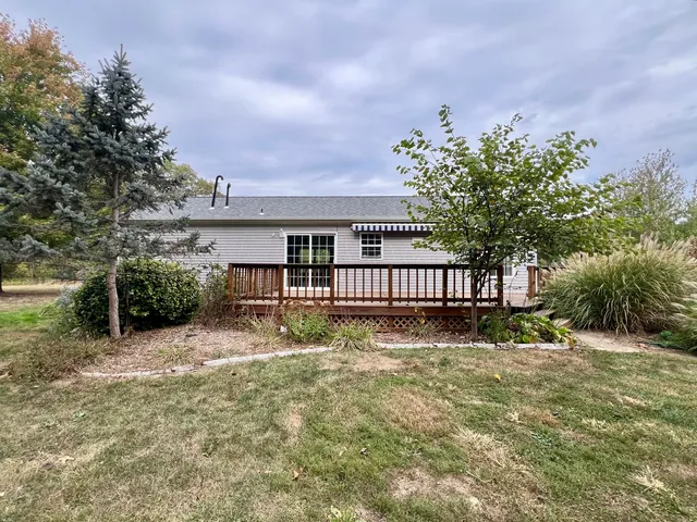 a view of house with a yard