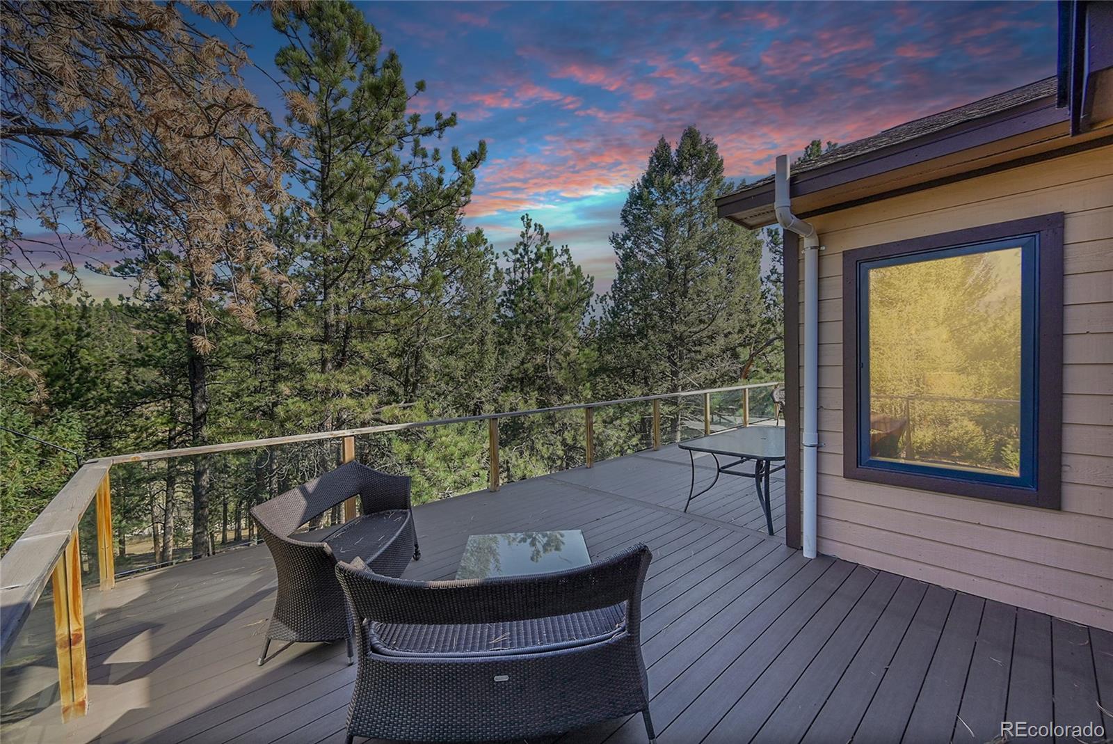 502 County Road 1034 Bailey, CO 80421 - Photo 2 of 20 a balcony with wooden floor table and chairs