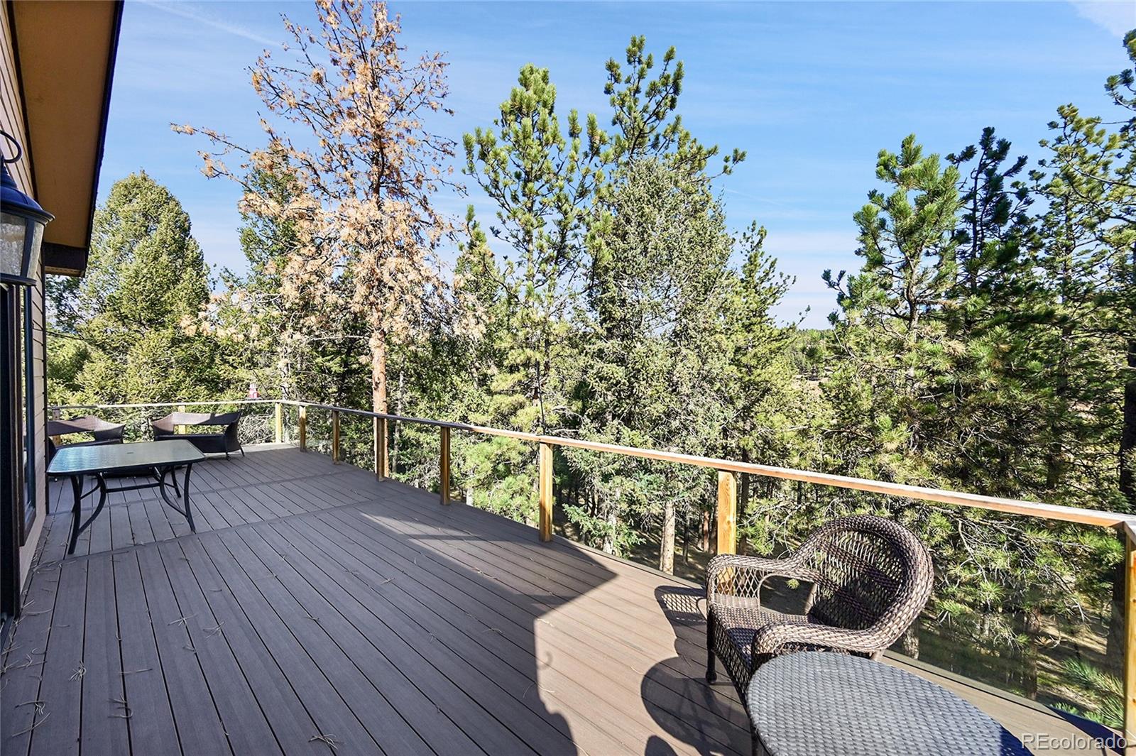 502 County Road 1034 Bailey, CO 80421 - Photo 8 of 20 a balcony with wooden floor table and chairs