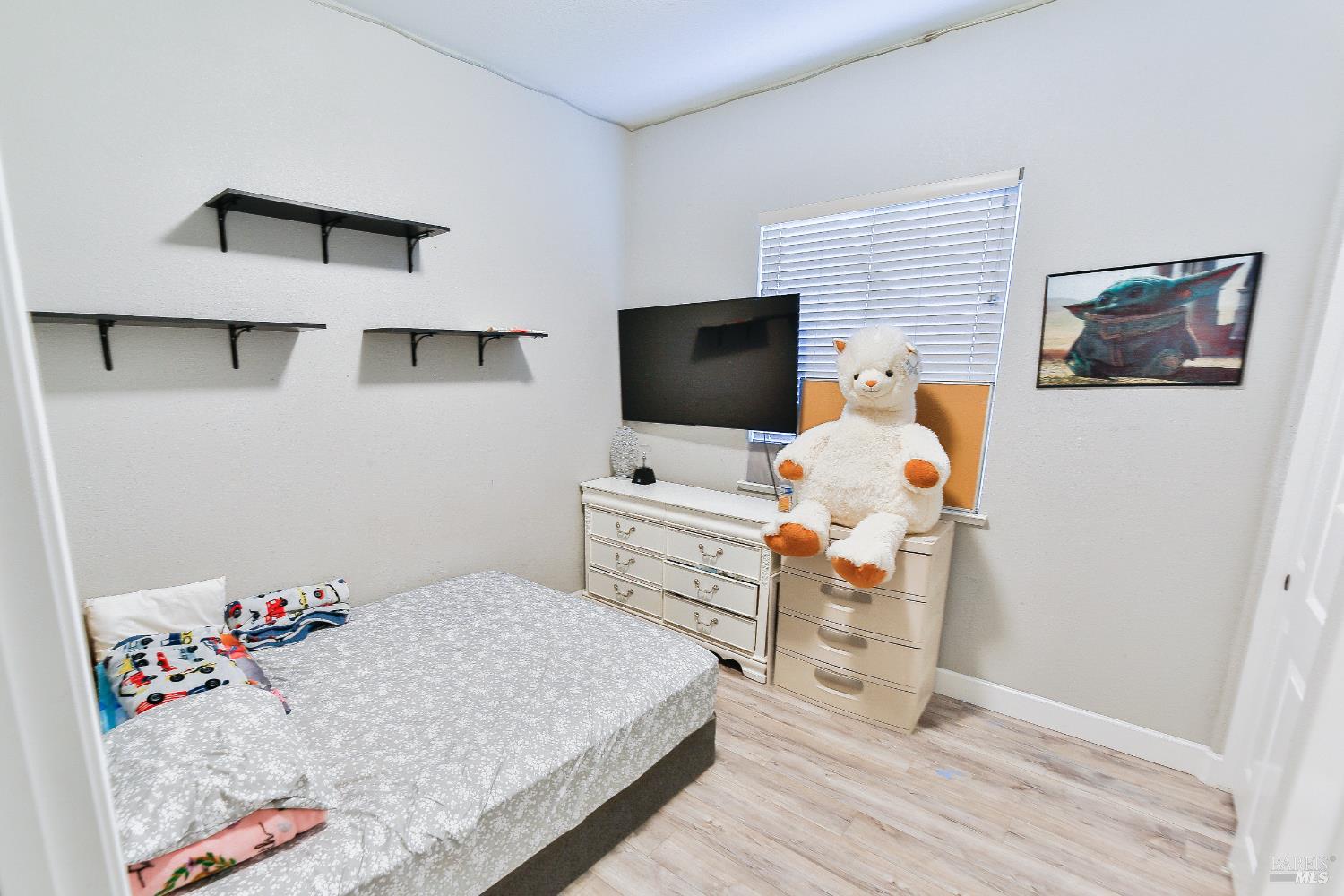 1331 Ridgecrest Court Santa Rosa, CA 95403 - Photo 10 of 19 a bedroom with a bed and flat screen tv