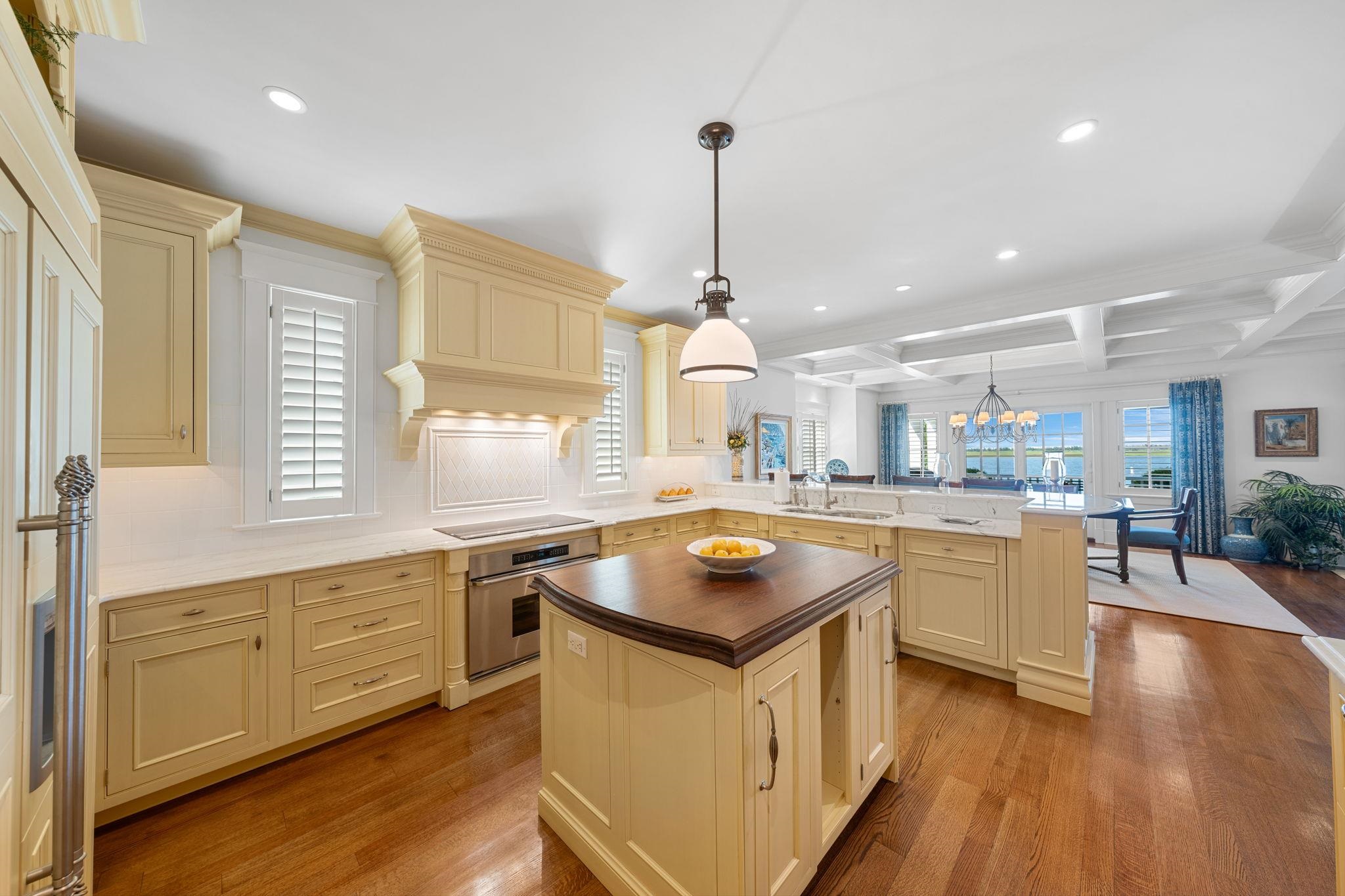 501 42nd Street Avalon, NJ 08202 - Photo 12 of 50 a kitchen with wooden floors and white cabinets