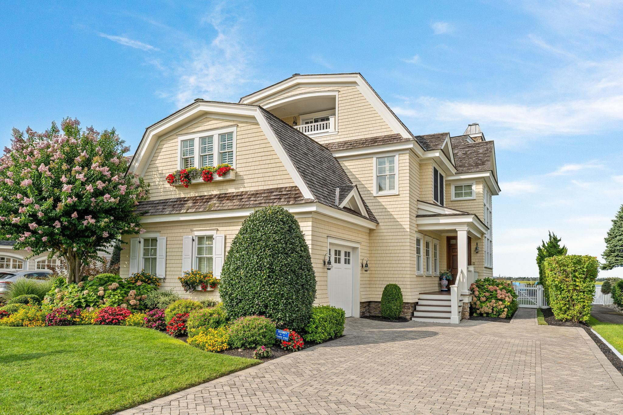 501 42nd Street Avalon, NJ 08202 - Photo 2 of 50 a front view of a house with a garden