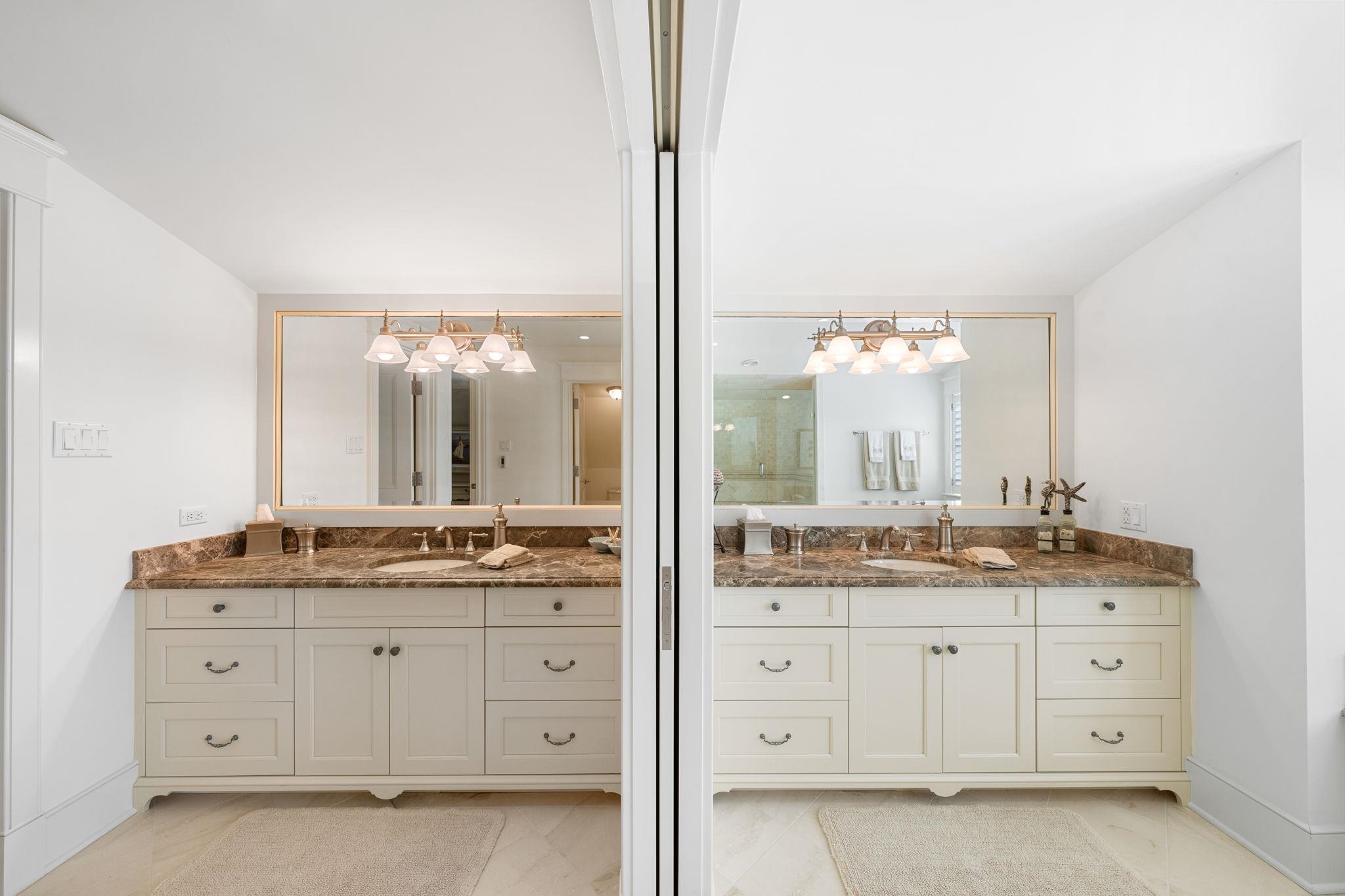 501 42nd Street Avalon, NJ 08202 - Photo 26 of 50 a bathroom with a granite countertop sink and a mirror