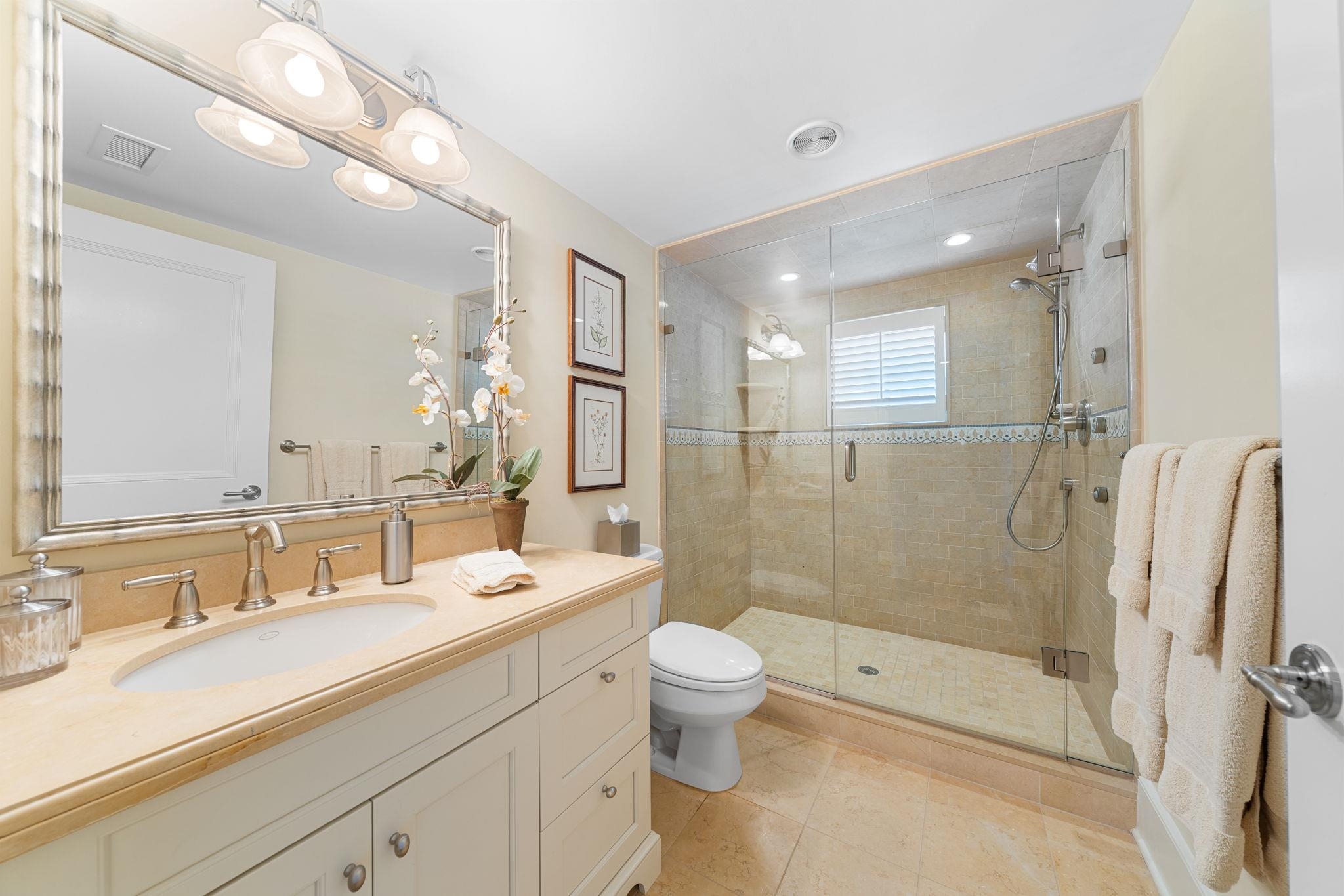 501 42nd Street Avalon, NJ 08202 - Photo 29 of 50 a bathroom with a double vanity sink toilet mirror and shower