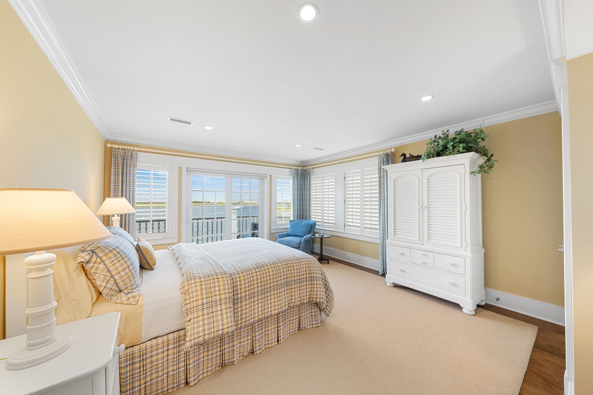 501 42nd Street Avalon, NJ 08202 - Photo 30 of 50 a bedroom with a large bed and wooden floor