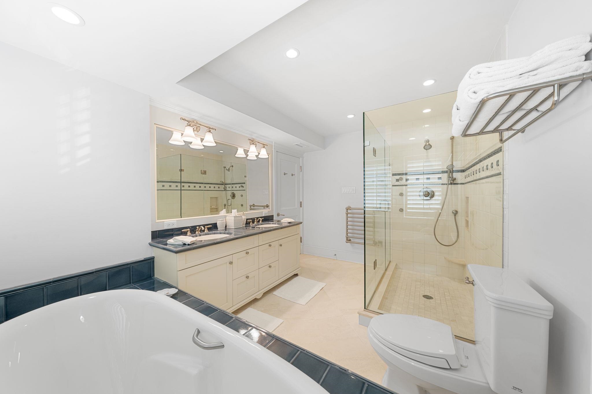 501 42nd Street Avalon, NJ 08202 - Photo 35 of 50 a bathroom with a granite countertop sink a toilet and shower