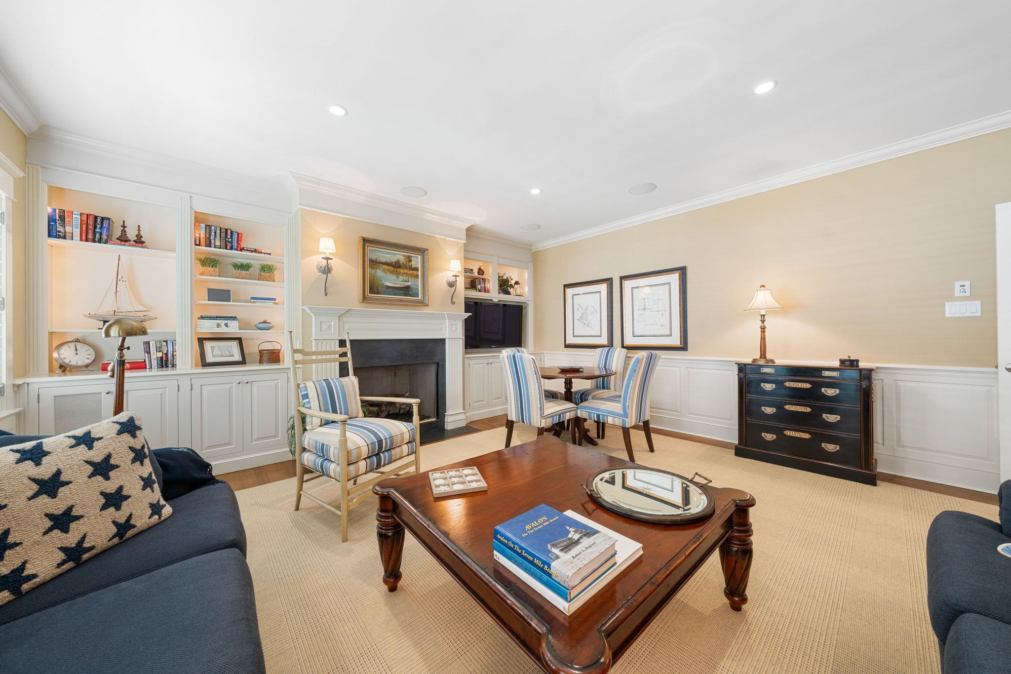 501 42nd Street Avalon, NJ 08202 - Photo 47 of 50 a living room with furniture a fireplace and a flat screen tv