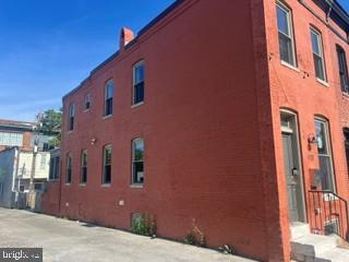 917 North Port Street Baltimore, MD 21205 - Photo 3 of 14 a front view of a building with large windows