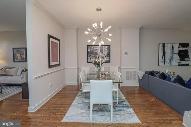 a living room with furniture a chandelier and a rug