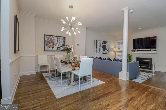 a view of a dining room with furniture wooden floor and chandelier