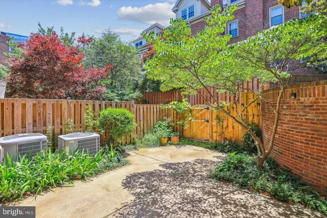 a garden with flowers and wooden fence