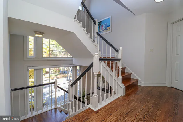 a view of staircase with wooden floor and door