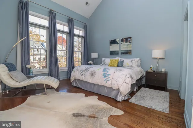 a bedroom with a bed and a large window