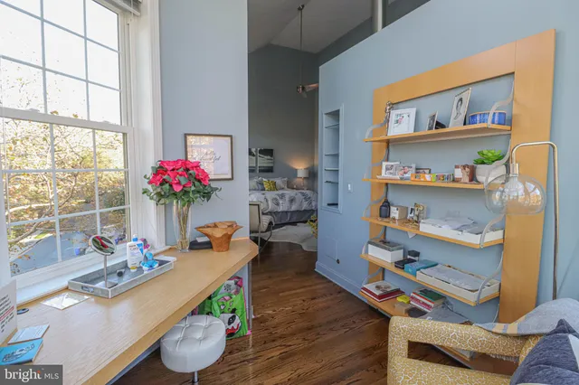 a living room with furniture and book shelf