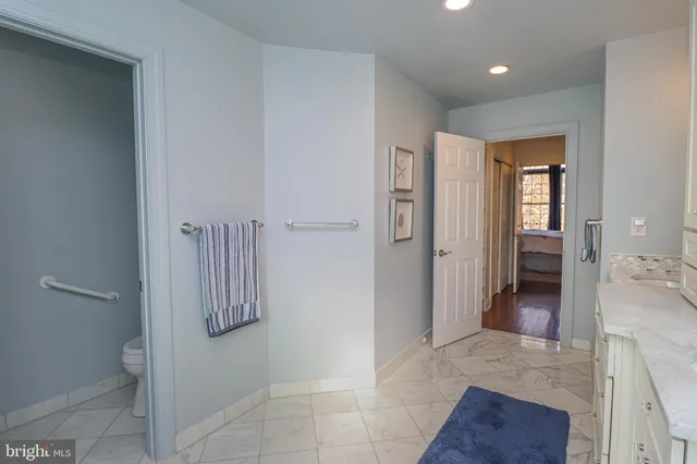 a view of a hallway with bathroom and bathroom