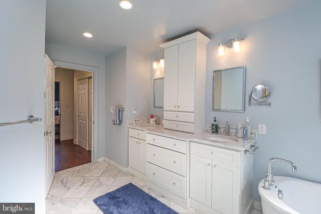 a bathroom with a double vanity sink and a mirror