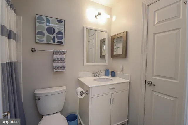 a bathroom with a toilet sink and mirror