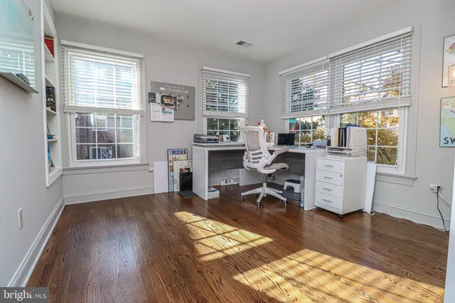 a workspace with furniture window and wooden floor