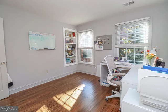a workspace with furniture hardwood and a window