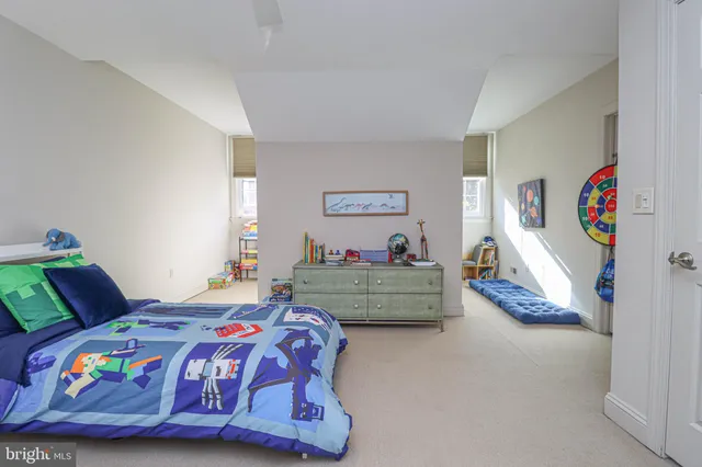 a bedroom with a bed and a couch