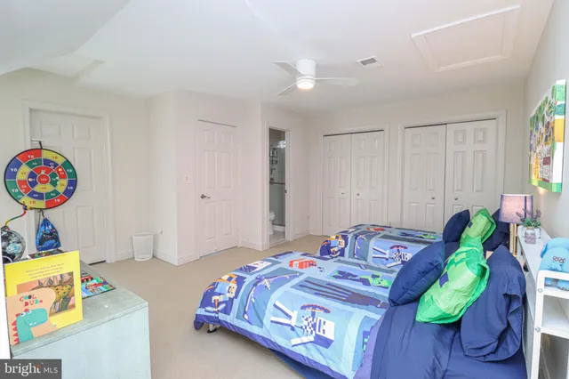 a bedroom with a bed and a wooden floor