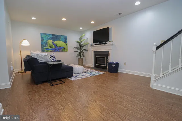 a living room with furniture a fireplace and a flat screen tv