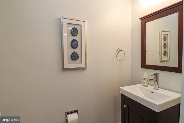 a bathroom with a sink mirror and vanity