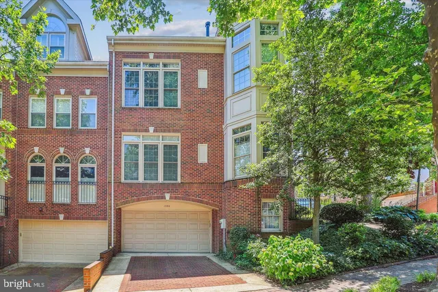 front view of a brick house with a yard