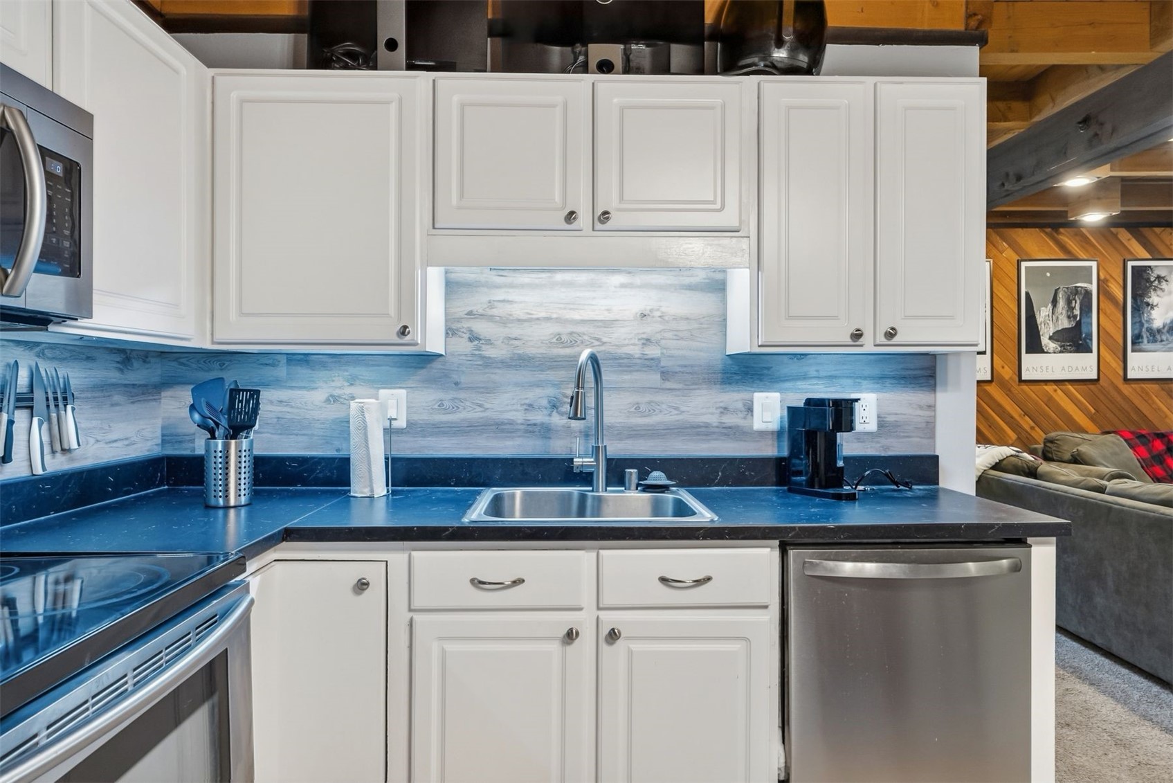 8100 Ryan Gulch Road, Unit 106 Wildernest, CO 80498 - Photo 5 of 43 a kitchen with granite countertop a sink a stove and cabinets