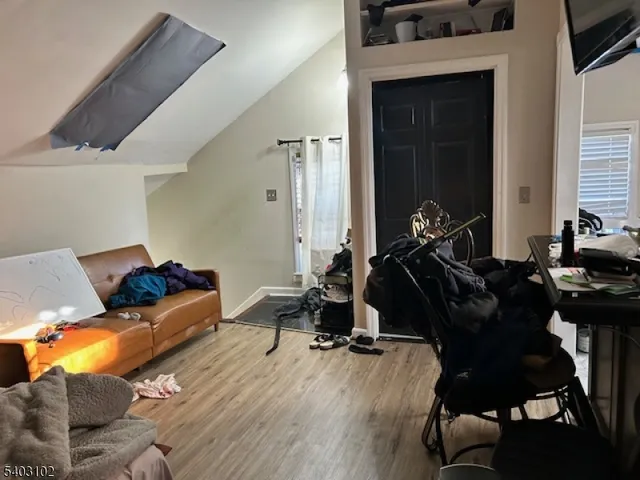 a living room with furniture a air conditioner vent and a window