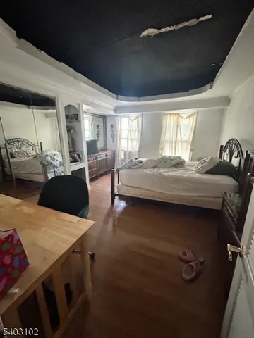 a bedroom with furniture and wooden floor