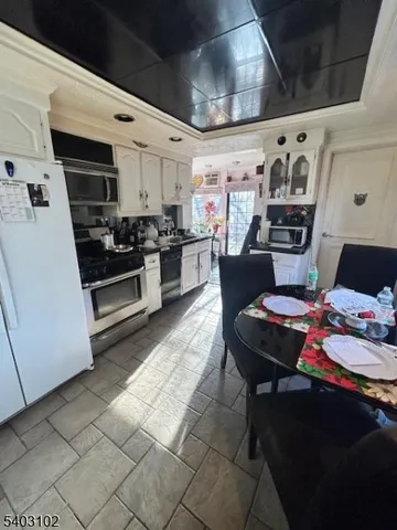 a kitchen with stainless steel appliances kitchen island granite countertop a sink and cabinets